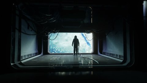 alone astronaut in futuristic space corridor, room. view of the earth. cinematic 4k footage.