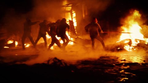 Kiev, Ukraine, January 2014: Protesters throw tires to the fire, exploding stun grenades. During the protests against President Yanukovych in Kyiv on the street Grushevskogo January 19, 2014