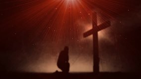 Man praying at the cross. Christian Cross background video.