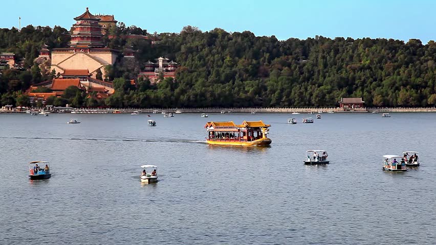 Tourist ancient boat and the view of the Summer Palace and Kunming Lake in Beijing, China