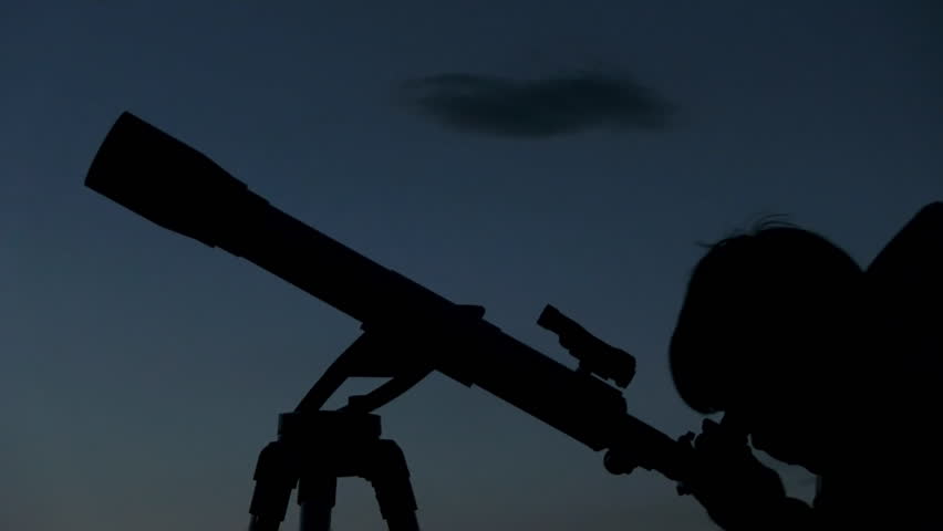 silhouette of telescope and astronomer