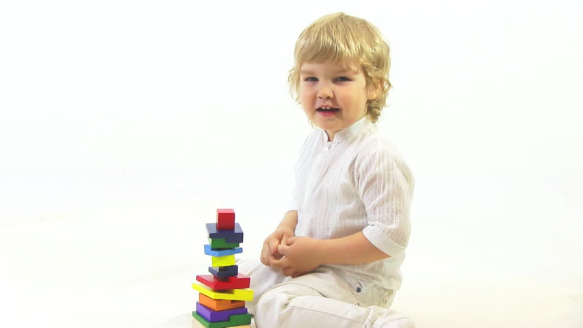 boy playing with toy in white room