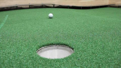 Mini Golf - Ball Going Into Hole on Astroturf