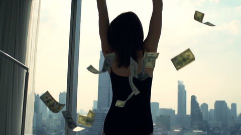 Successful, happy woman throwing money by window at home, super slow motion 240fps 

