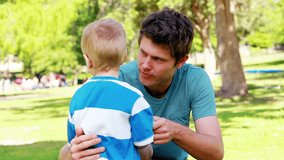 Boy telling who has broken his toy to his father in a park - Powered by Shutterstock - Get 15% off with code: PIKWIZARD15