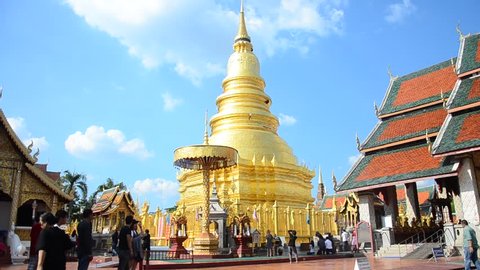LAMPHUN, THAILAND - DECEMBER 28 : Asian thai people and foriegner people respect praying and walk visit gold chedi at Wat Phra That Hariphunchai temple on December 28, 2016 in Lamphun, Thailand.