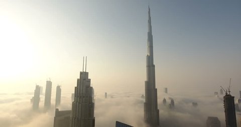 DUBAI, UAE - JANUARY 2, 2017: Aerial view of Burj Khalifa downtown Dubai at sunrise. The Burj al Khalifa is the tallest structure in the world, standing at 829.8 m (2,722 ft). Scenic foggy weather
