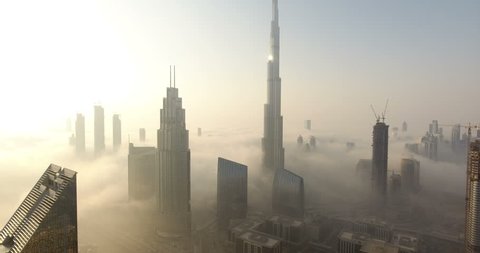 DUBAI, UAE - JANUARY 2, 2017: Aerial view of Burj Khalifa downtown Dubai at sunrise. The Burj al Khalifa is the tallest structure in the world, standing at 829.8 m (2,722 ft). Scenic foggy weather.