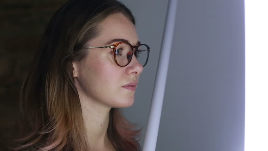 Girl looks at a visual installation. A new kind of art, generative graphics. Audio-visual exhibition 