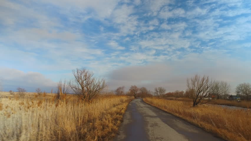 Driving on a country road. Autumn. Use a Steadicam Shot.