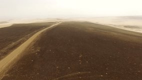 AERIAL: Car in desert on road: Peru, South america, UHD / 4k video footage