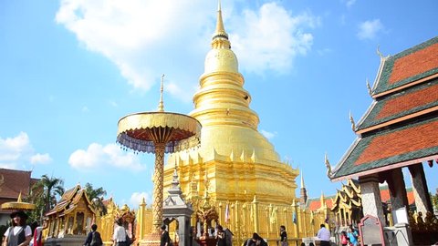 LAMPHUN, THAILAND - DECEMBER 28 : Asian thai people and foriegner people respect praying and walk visit gold chedi at Wat Phra That Hariphunchai temple on December 28, 2016 in Lamphun, Thailand.