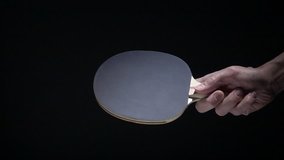 Hand holding table tennis racket and serve ping pong ball. Slow motion film clip with sport equipment.