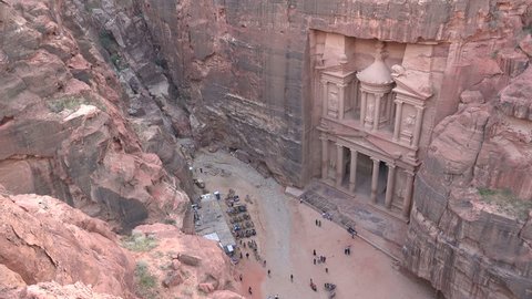 PETRA, JORDAN - NOVEMBER 2016: Tourists visit the imposing Treasury building in the ancient city of Petra