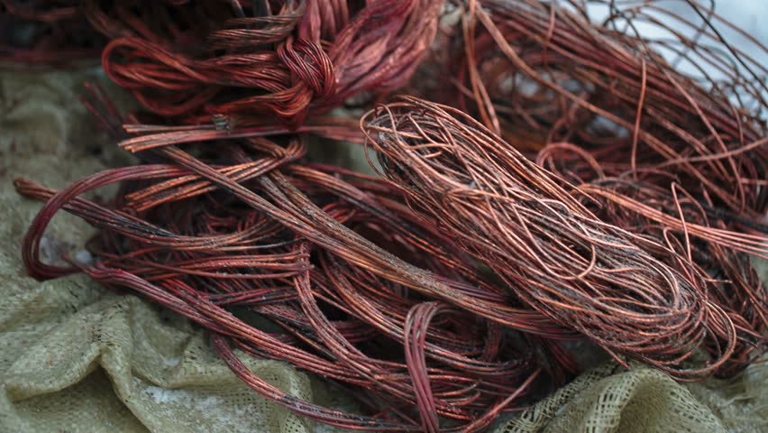 Bare copper wires on a close-up of snow