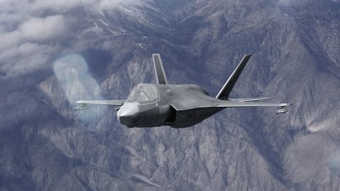 4k F-35 Fighter Jet over the mountains firing a missile and then peeling away stock video clip. Joint strike fighter