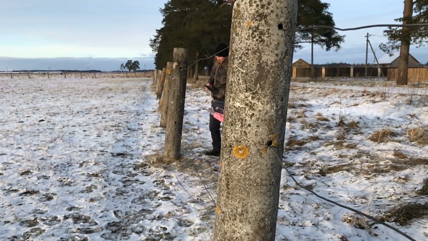 father and daughter in a field at sunset in winter in slow motion