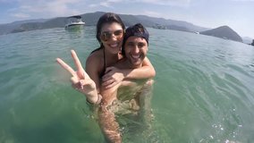 Couple taking a selfie and having fun in a Beach in Brazil - Powered by Shutterstock - Get 15% off with code: PIKWIZARD15