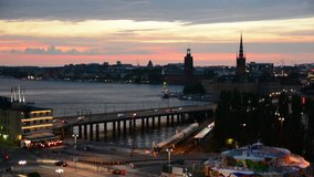 View of Stockholm cityscape at dusk. Traffic and trains passing by