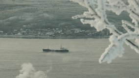 Snow-covered tree branches against the backdrop of the ship sailing on the bay. Winter frost.
 - Powered by Shutterstock - Get 15% off with code: PIKWIZARD15