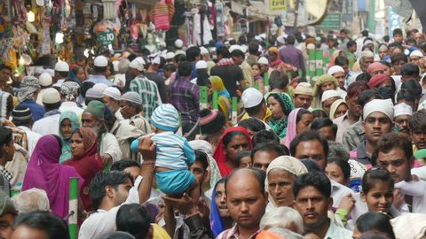 AJMER, INDIA - OCTOBER 2014: Massive colorfully dressed crowds walk through a narrow street during the Islamic celebrations of Muharram in Ajmer, India
