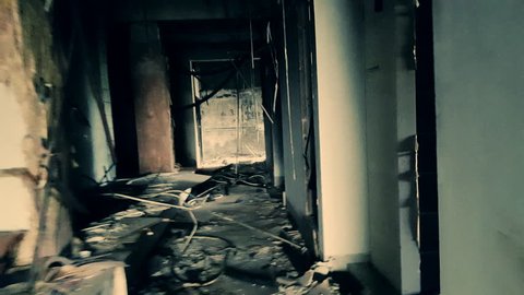 Handheld camera brokenly moves through hall of abandoned factory. Industrial building after technological disaster concept. Horror quest game scene. First-person perspective, shaky live cam view.