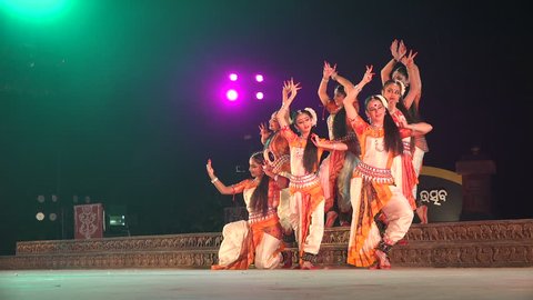 KONARK, INDIA - DECEMBER 2014: An all girl Indian dance group takes on a classic pose during a traditional performance on stage in Konark
