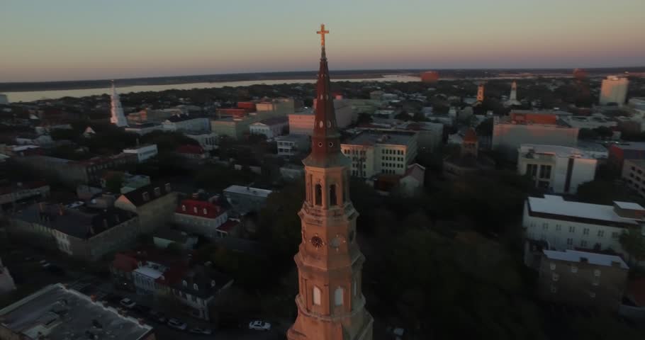 Aerial of downtown Charleston sunrise with Saint Philip Church in the foreground.
