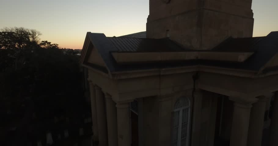 Aerial of downtown Charleston sunrise with Saint Philip Church in the foreground.