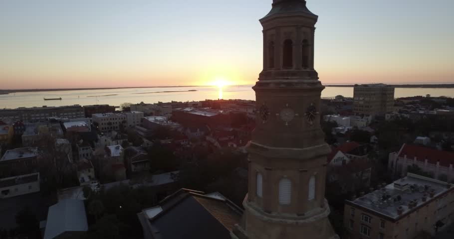 Aerial of downtown Charleston sunrise with Saint Philip Church in the foreground.