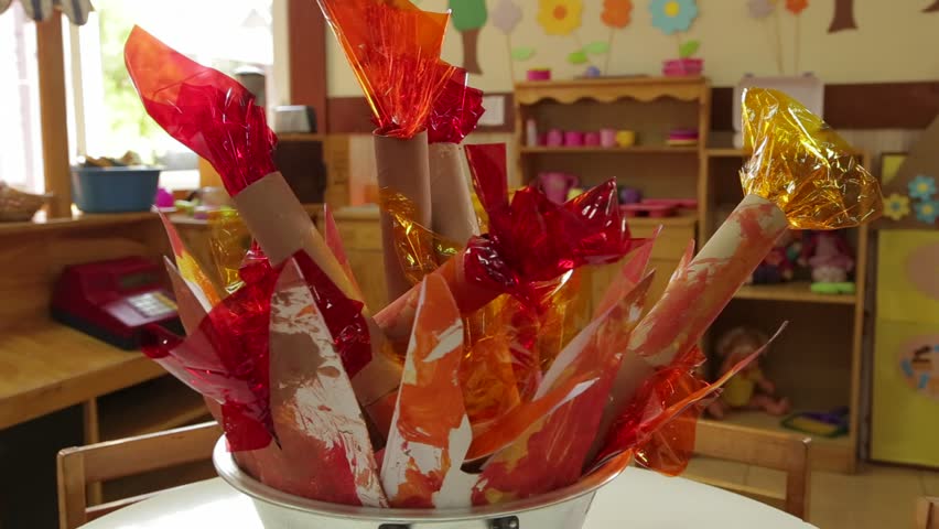 Camera moves away fro a pot filled with empty paper towel rolld filled with celophane. (Santiago, Chile - Feb 2016)