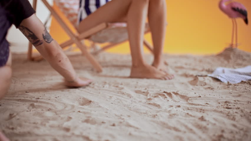 Getting ready background sand beach decorations for shooting in studio. Slow motion.