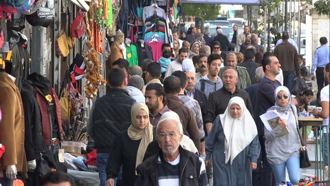AMMAN, JORDAN - NOVEMBER 2016: Crowds of pedestrians walk through a popular shopping street in downtown Amman, Jordan
