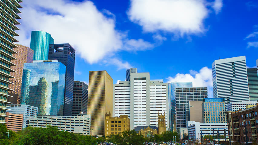 Houston Texas Skyline Clouds Time Lapse 4K 1080p. A time-lapse of Houston cityscape with clouds rolling over buildings and blue skies
