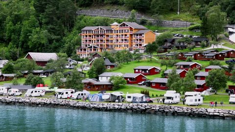 GEIRANGER - JUNE 28: Grande Fjord Hotel in coastal village under mountain with forest on JUNE 28, 2011 in Gieranger, Norway. In hotel are totally 48 rooms and 40 of them with fjord view and balcony