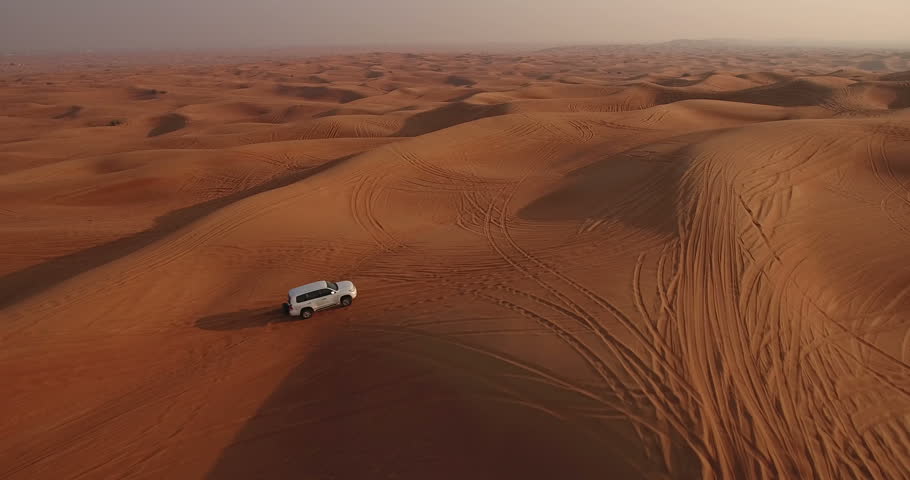 Aerial view of 4x4 off road land vehicle taking tourists on desert dune bashing safari in Dubai, UAE Royalty-Free Stock Footage #23180068
