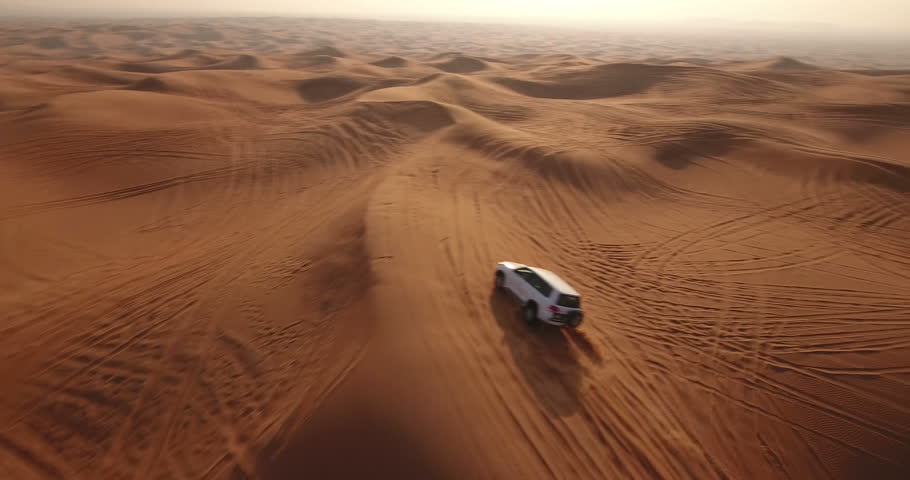 Aerial view of 4x4 off road land vehicle taking tourists on desert dune bashing safari in Dubai, UAE Royalty-Free Stock Footage #23180110