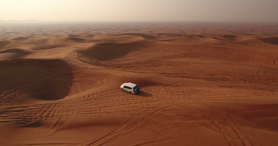 Aerial view of 4x4 off road land vehicle taking tourists on desert dune bashing safari in Dubai, UAE Royalty-Free Stock Footage #23180152
