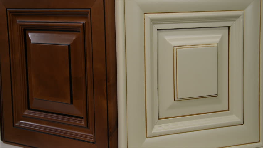 Six beautiful wooden kitchen panels mixed up and standing as a door samples in commercial show room. Background is blurry in slow motion, kitchen doors concept  Royalty-Free Stock Footage #23180998