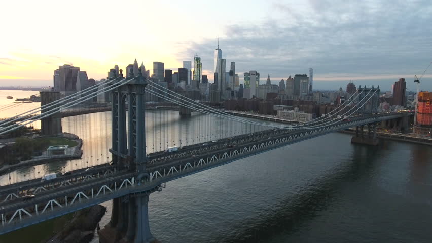 An aerial shot of New York City's skyline at sunset. Shot during the summer of 2016 4k. The camera flies over The East River looking towards Manhattan. Royalty-Free Stock Footage #23198923