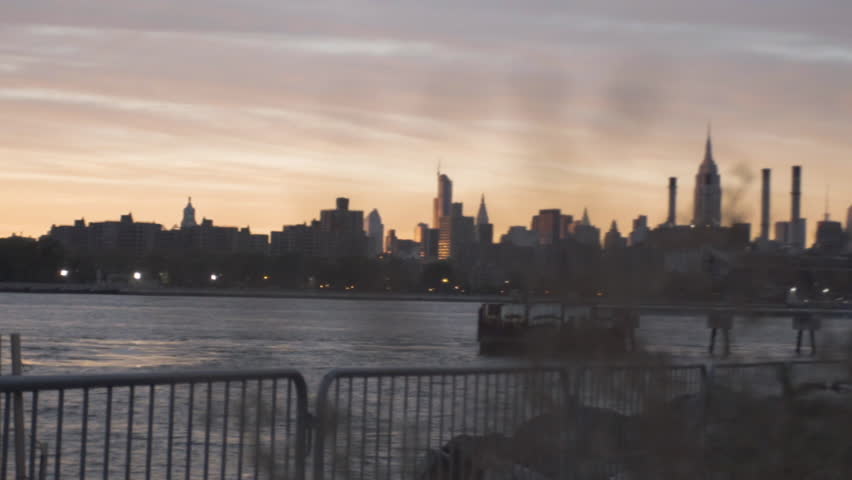 An establishing shot of New York City's Empire State Building. Shot from across The East River in Williamsburg Brooklyn. Shot during the summer of 2016.