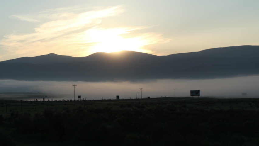 Thick layer of fog envelopes a peaceful valley in northern New Mexico at dawn.