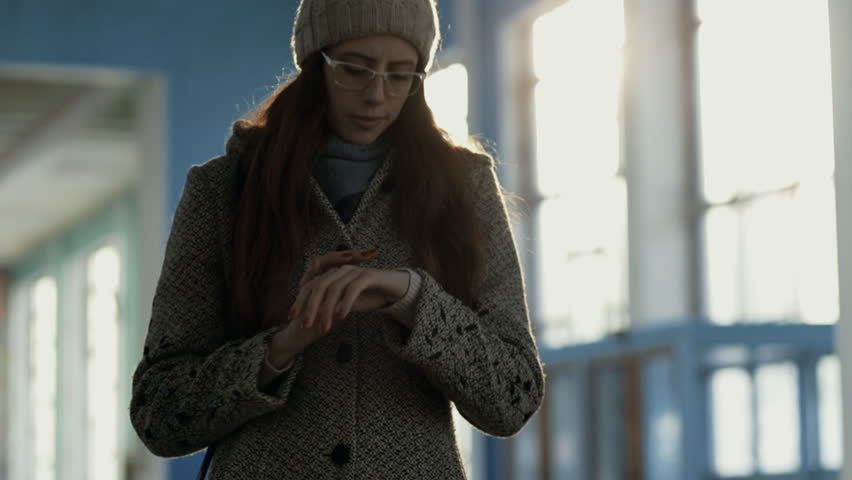 Woman waiting her friend which is late come in old railway station