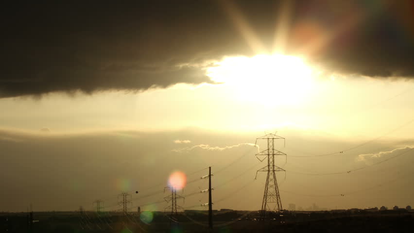 Ominous sunset, with power lines silhouetted in the foreground. HD 1080p time