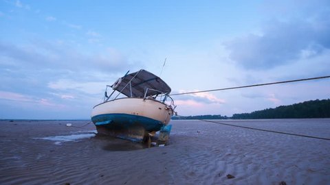 Time-lapse -sunset beach with fishing boat