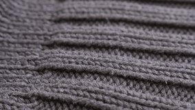 Slow tilt on thick wool ribbing or stockinette stitch knitting work 4K 2160p 30fps UltraHD footage - Close-up of man brown sweater details and knitwork 3840X2160 UHD tilting video