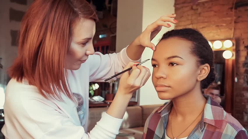 Makeup artist doing make-up beautiful african model. | Shutterstock HD Video #23224144
