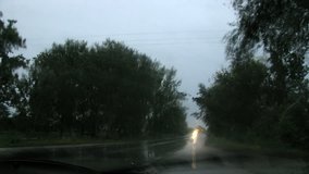 High definition time lapse sequence of from interior of car driving on road in the rainy night