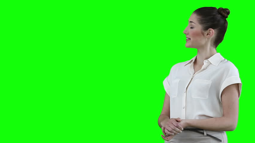 Businesswoman making a presentation with a virtual slideshow against a green background