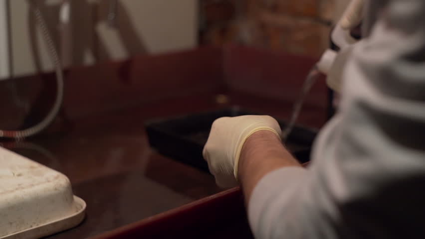 Man pours a liquid in a container close-up